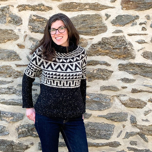 Front view of Kate wearing her Black and light gray colorwork Newbold Sweater knit in Kelbourne Woolens Lucky. Sweater has been modified to be a turtleneck