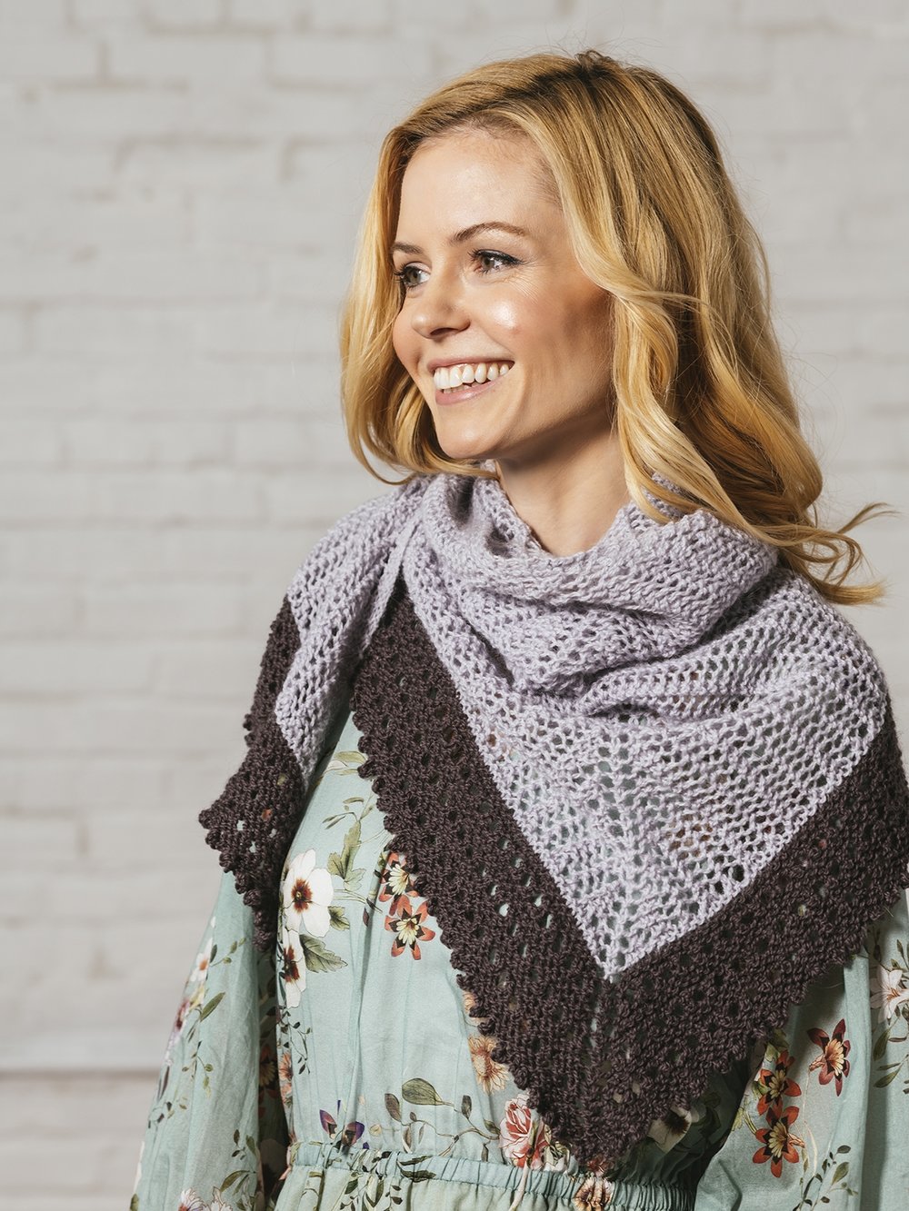 Blonde woman wearing Evangelina, a pale gray and purple lace shawl in Andorra