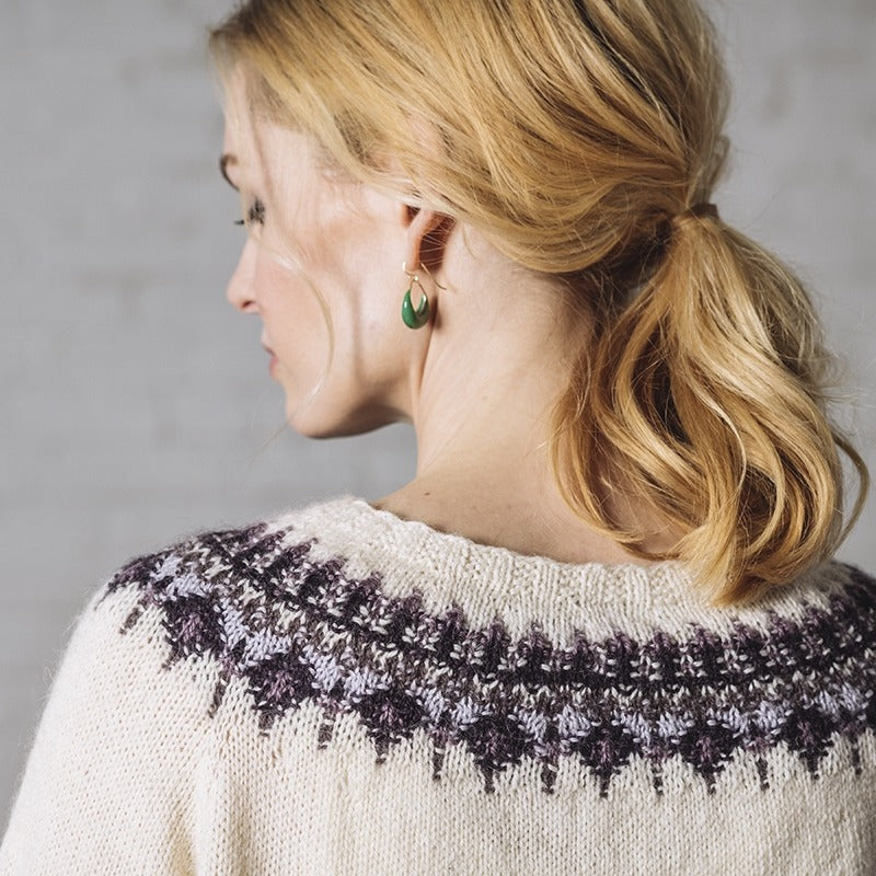 Close up back view of blonde woman wearing Jenny, a feminine bohus yoke pullover in white with purple details